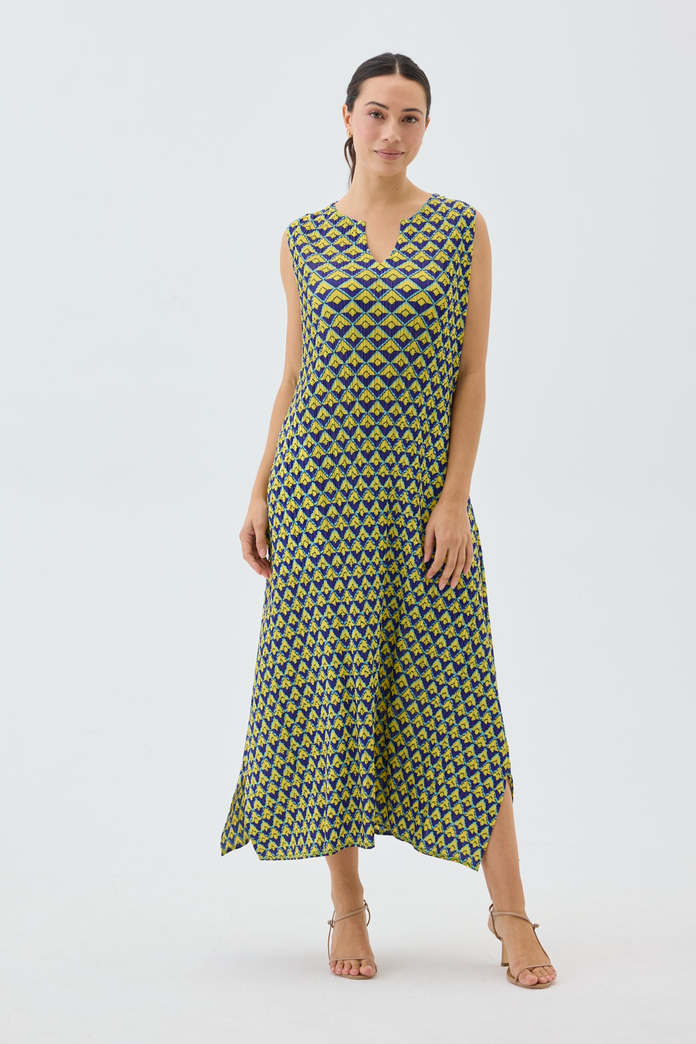 Woman wearing a patterned dress on a white background