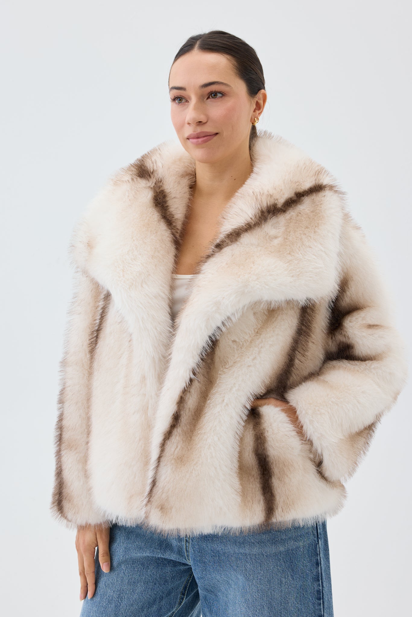 Woman wearing a fur coat with a neutral background