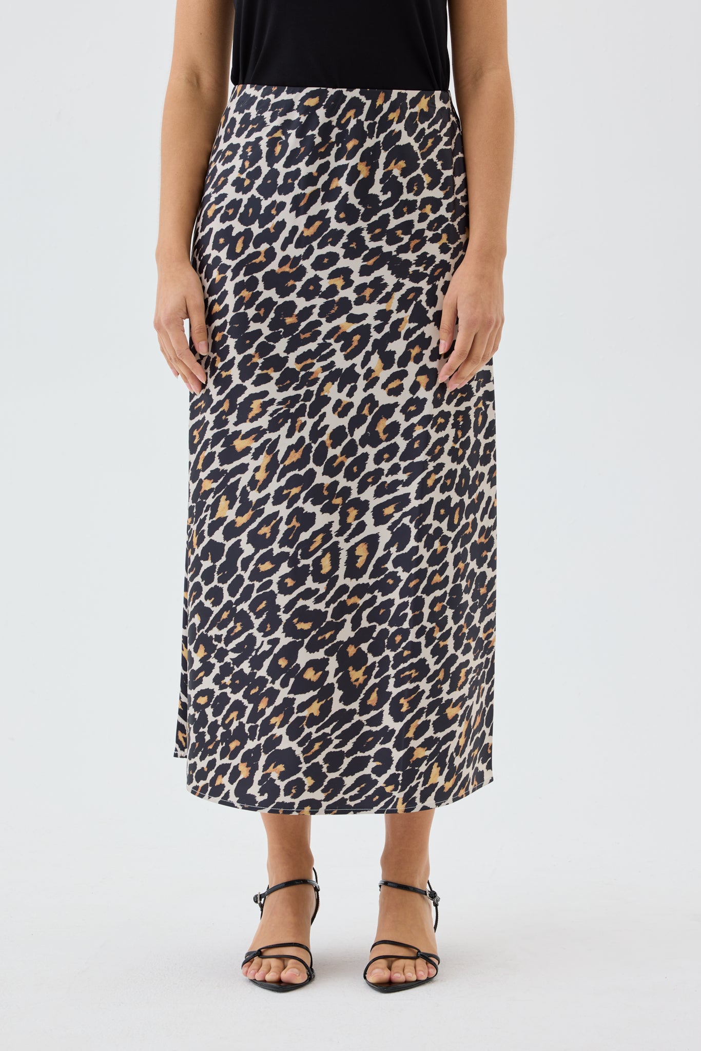 Person wearing a leopard print skirt on a white background